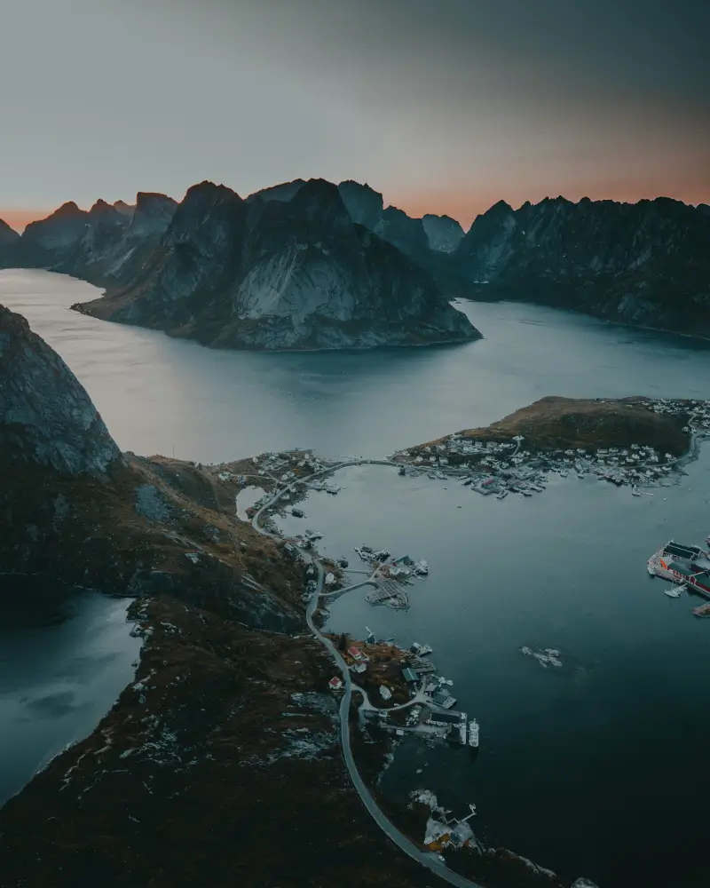 Aerial view of the Lofoten Islands with their steep mountains, fjords, and coastline.