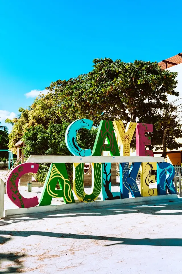 Giant hand-painted sign reading “Caye Caulker”, visible when you arrive on the island.