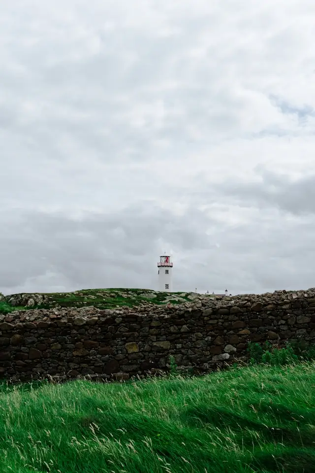 Stone wall with Fanad Head lighthouse in the distance.